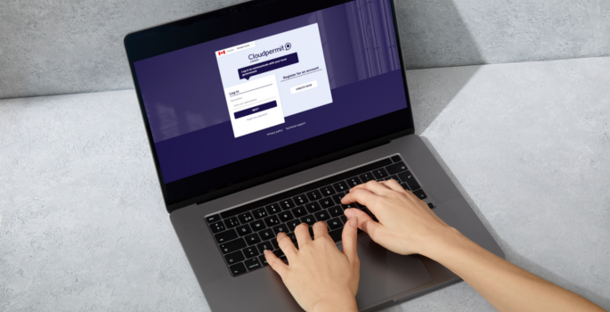 Hands typing on a laptop with Cloudpermit application on the screen