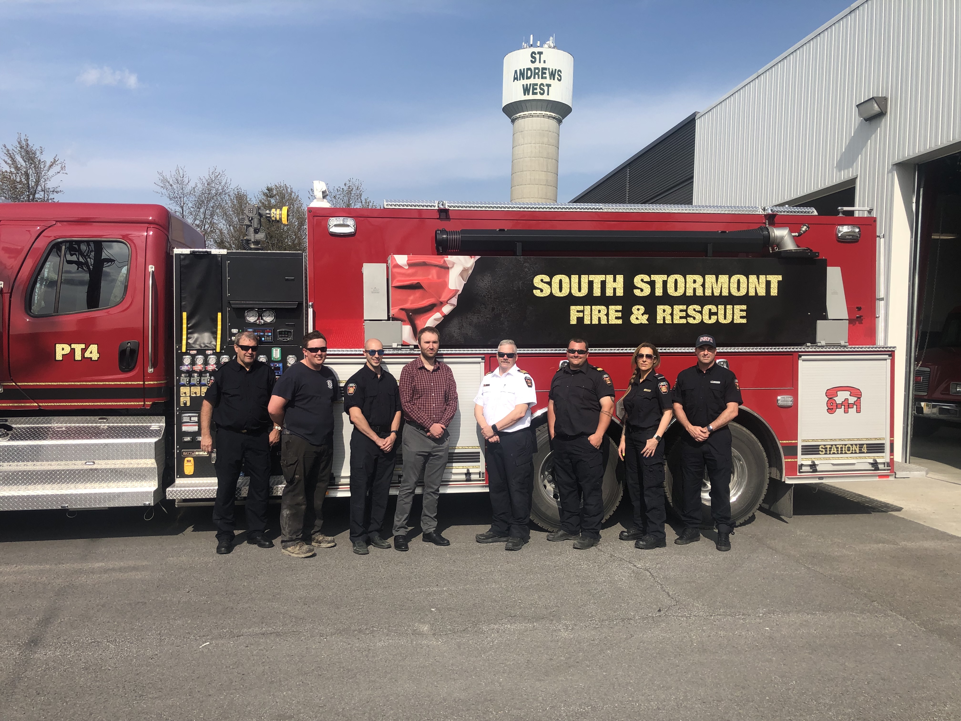 Firefighters posing in front of new fire truck