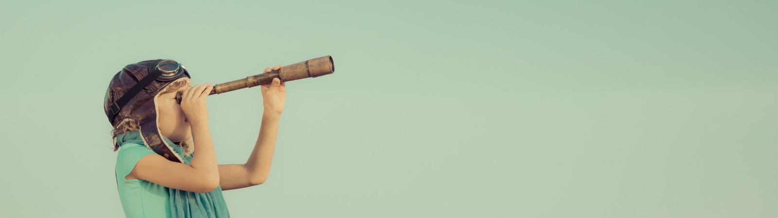 Young girl looking through telescope