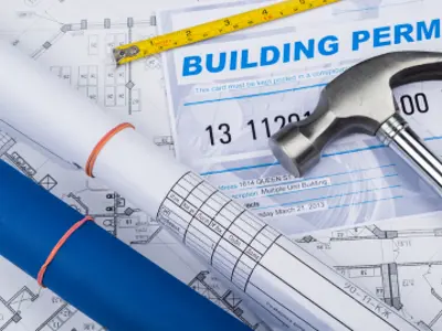 Building Plans with a hammer laid on them
