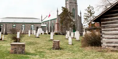 Headstones in a cemetery with large church in the background